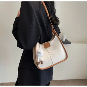Retro cream white bucket bag for women with dark brown trim and cute plush pendant charm