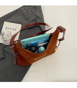 Brown suede shoulder bag interior showing capacity for tablet, umbrella, and essentials