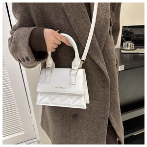 Chic white PU leather crossbody bag featuring quilted diamond pattern on a wool coat