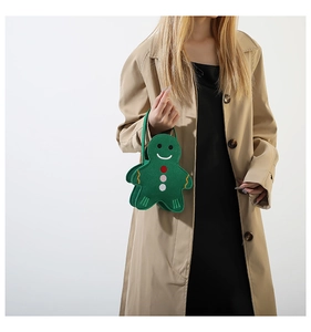 Green gingerbread man felt tote bag with embroidery details held by a model