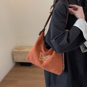 Brown suede tote bag with white butterfly embroidery and dual metal chain straps