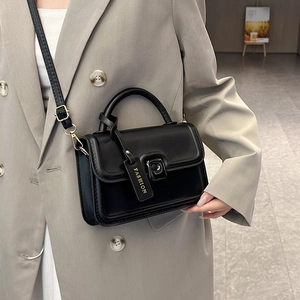 Chic black minimalist square crossbody bag with gold hardware and side knot detail