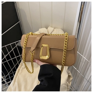 Detail showing khaki faux leather crossbody bag with a polished golden U-shaped buckle