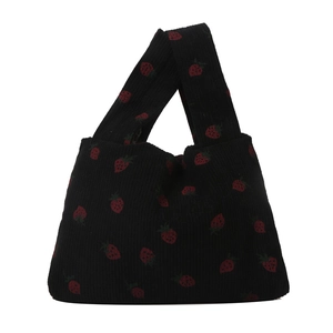 Minimalist black corduroy handbag featuring cute red strawberry embroidery on white background