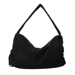Minimalist black oversized crescent tote bag made of pleated nylon for daily casual style