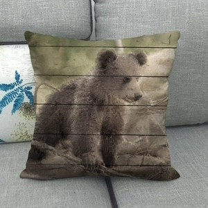 Linen pillow cover with realistic baby brown bear print on vintage wood texture background