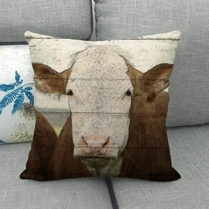 Detail of linen pillow case with realistic cow print and rustic wood texture on grey sofa
