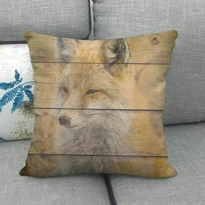 Detailed view of fox portrait linen pillowcase on sofa with retro wood grain pattern