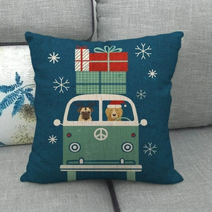 Detail of linen cushion cover showing a cartoon bus with dogs and holiday scene on sofa