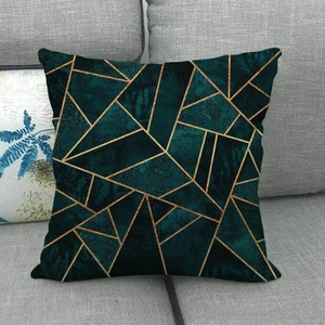 Detail of dark green linen cushion cover with gold irregular geometric pattern lines