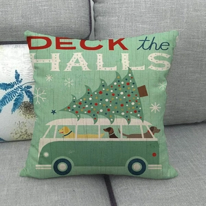 Detail of Christmas linen pillowcase featuring DECK the HALLS text and a retro bus with dogs