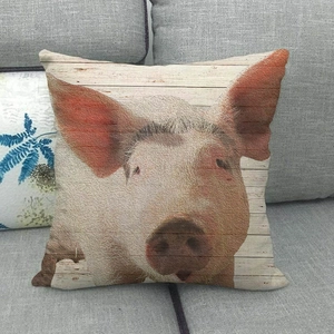 Detailed texture of linen pillowcase with realistic pig print on a grey fabric sofa