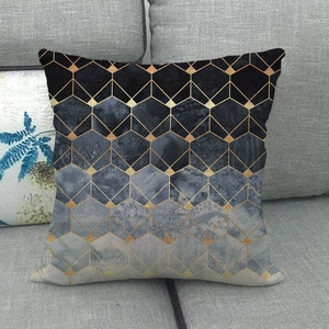 Detail of linen pillow cover with gold hexagonal honeycomb pattern and blue gradient