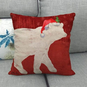 Detailed texture of red Christmas pillowcase featuring white polar bear and pine trees