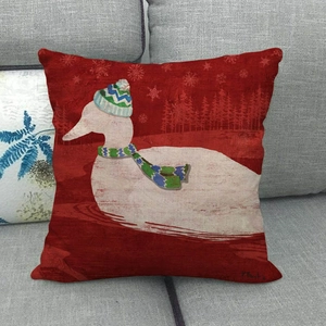 Red linen Christmas pillow cover with white duck in scarf on a gray sofa