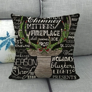 Detail of rustic linen pillow cover featuring a wooden texture deer head and winter typography