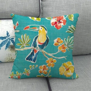 Detail of toucan and tropical floral print on textured linen cushion cover