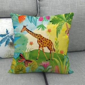 Close-up of giraffe and tropical floral print on a textured linen sofa cushion cover