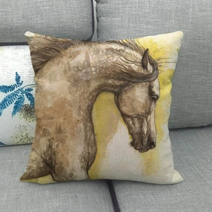 Linen square pillow featuring a vintage watercolor horse head design on a grey fabric sofa