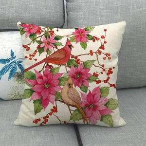 Detailed macro view of linen texture and cardinal bird floral print on cushion cover