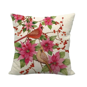 Linen pillow cover featuring red cardinals, poinsettia flowers, and berries on cream fabric