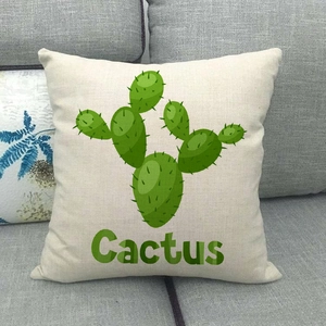 Gros plan d'une taie d'oreiller en lin cactus sur un canapé en tissu gris