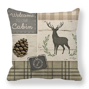 Detail of linen cushion cover showing rustic deer and pinecone cabin decor design