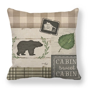 Detailed texture of rustic linen pillowcase with cabin bear pattern and plaid border
