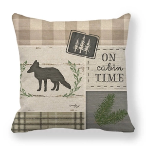 Detail of linen cushion cover with woodland fox, pine trees and cabin time print