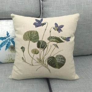 Detailed texture of linen cushion cover with vintage purple floral print on grey sofa