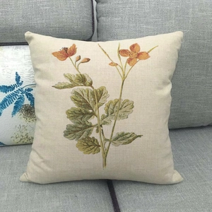 Detailed view of square linen pillowcase with vintage botanical orange flower print