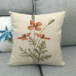 Detail of linen pillowcase featuring artistic red floral prints on a beige fabric base