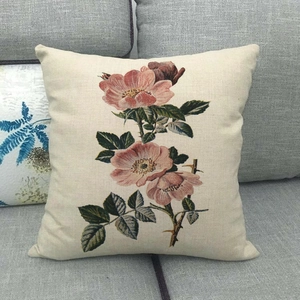Detailed texture of linen cushion cover with floral print on a gray sofa