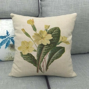 Detailed weave texture of linen cushion cover with yellow flower and green leaves