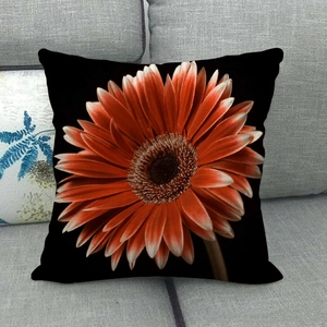 Detail of orange gerbera flower print on a black linen square throw pillow cover