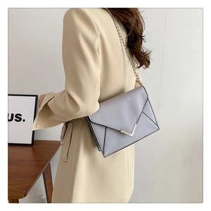 Chic lavender envelope bag with V-shaped silver buckle and metal chain shoulder strap