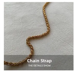 Detail of a bright golden metal chain strap with intricate spiral woven texture