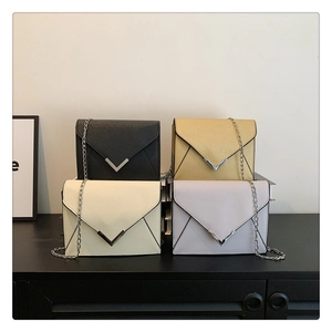 Collage of four chain crossbody flap bags in black, yellow, beige and lilac colors