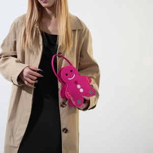 Gingerbread man shaped magenta felt tote bag with embroidery shown on model