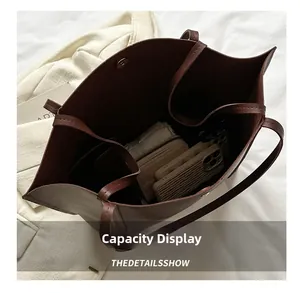 Internal view of large brown faux leather tote bag showing spacious capacity and pockets