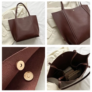 Detail showing high-capacity brown tote bag interior and magnetic buckle closure