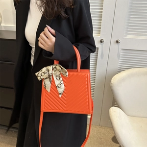Orange V-quilted handbag with silk scarf handle, stylish square crossbody bag for women