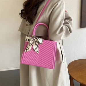 Pink V-quilted square crossbody bag with silk scarf handle and slim shoulder strap