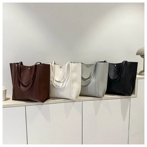Selection of large tote bags in brown, white, gray, and black colors for daily commuting