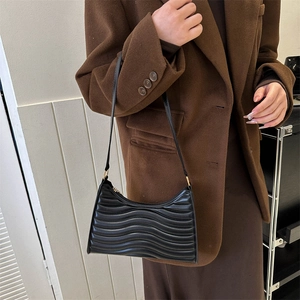 Black wavy quilted shoulder bag for women with gold hardware and chic leather strap