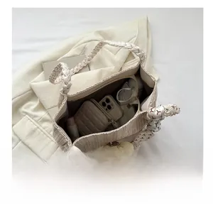 Top view of woven tote bag showing spacious interior with pockets and daily essentials
