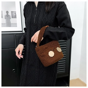 Close-up of fluffy brown teddy plush shoulder bag with cute cartoon bear face detail