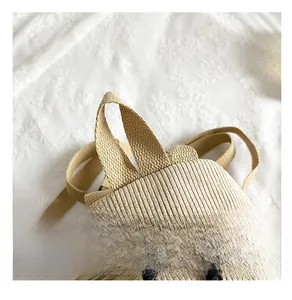 Detail of the corduroy backpack showing a sturdy top handle and smooth metal zippers