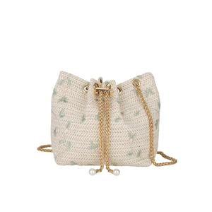 Minimalist straw bucket bag with floral embroidery and golden chain straps for women