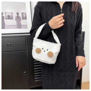 Close-up of white plush mini tote bag with cute bear face and soft faux fur texture